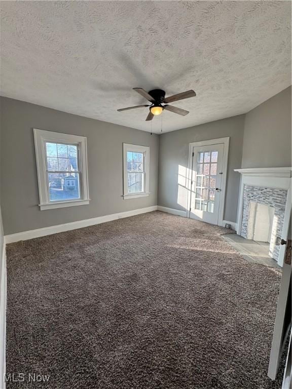 unfurnished living room with a healthy amount of sunlight and a textured ceiling