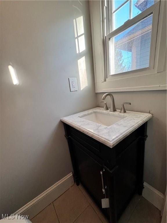 bathroom featuring tile patterned flooring and vanity