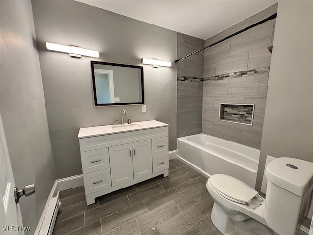 full bathroom featuring vanity, toilet, and tiled shower / bath