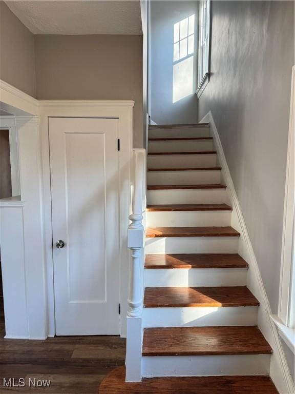 stairway with hardwood / wood-style floors