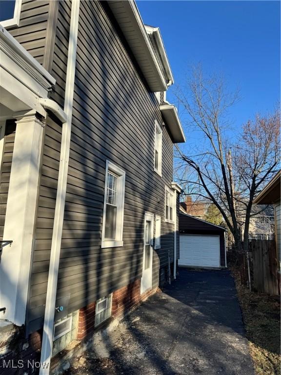 view of side of home with an outbuilding and a garage