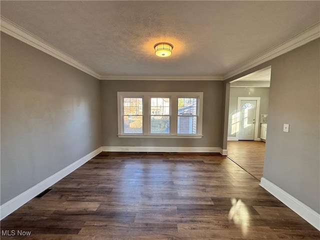 unfurnished room featuring a textured ceiling, dark hardwood / wood-style flooring, and crown molding