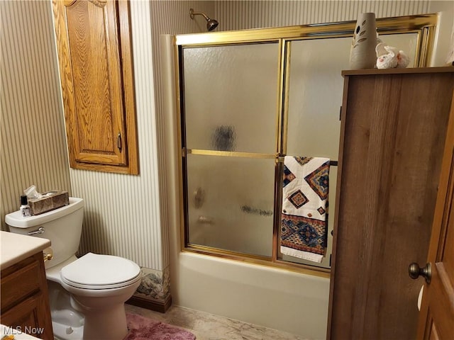 full bathroom featuring vanity, toilet, and combined bath / shower with glass door