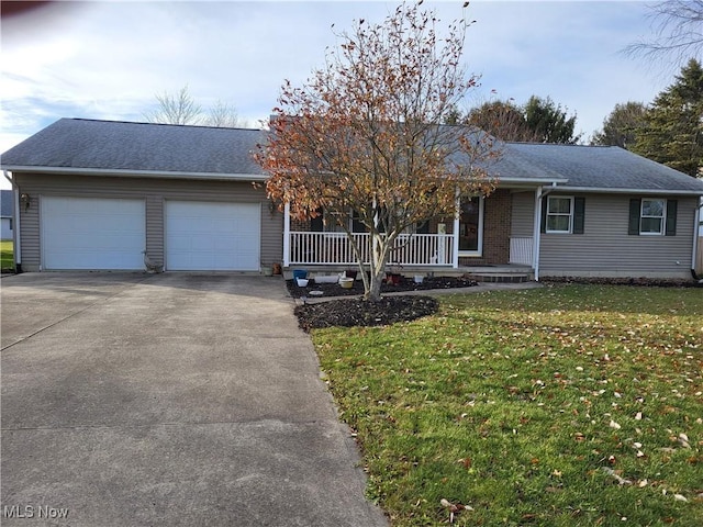 ranch-style home with covered porch, a front yard, and a garage