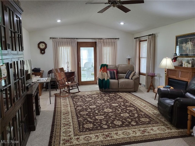 living room featuring light carpet, plenty of natural light, and lofted ceiling