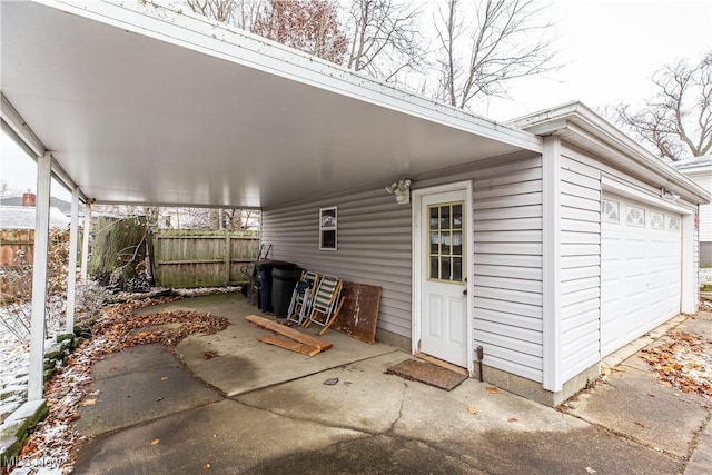 view of patio / terrace with a carport and a garage