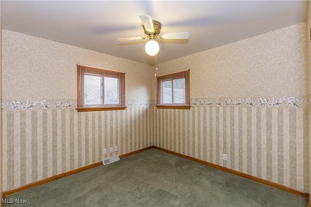 carpeted spare room with ceiling fan