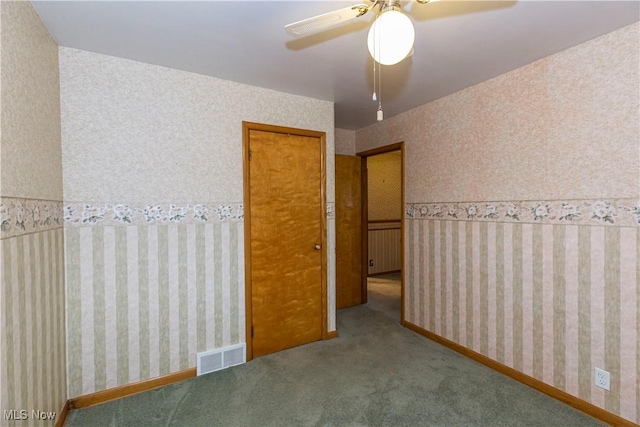 unfurnished bedroom featuring carpet and ceiling fan