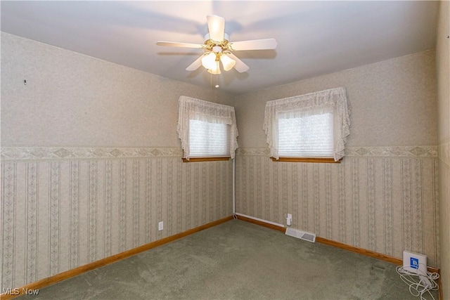 spare room featuring carpet flooring and ceiling fan