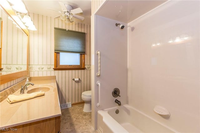 full bathroom featuring toilet, vanity, bathing tub / shower combination, and ceiling fan