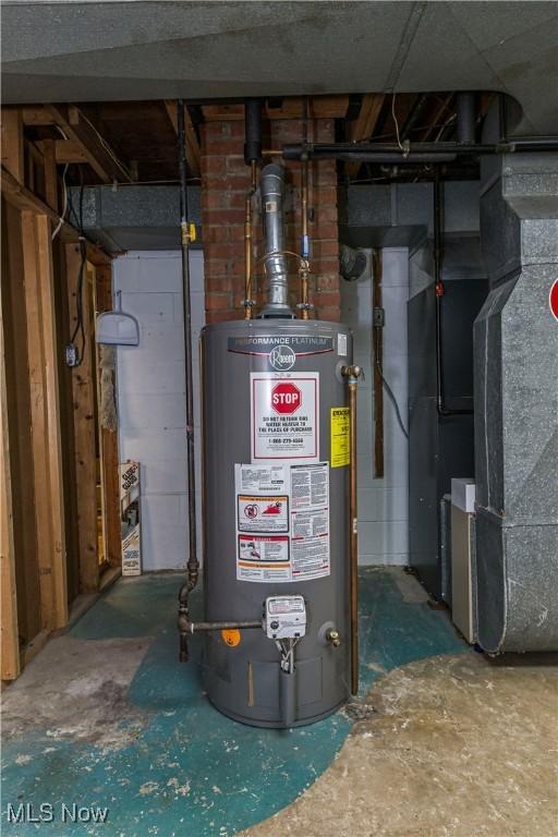 utility room with gas water heater and heating unit