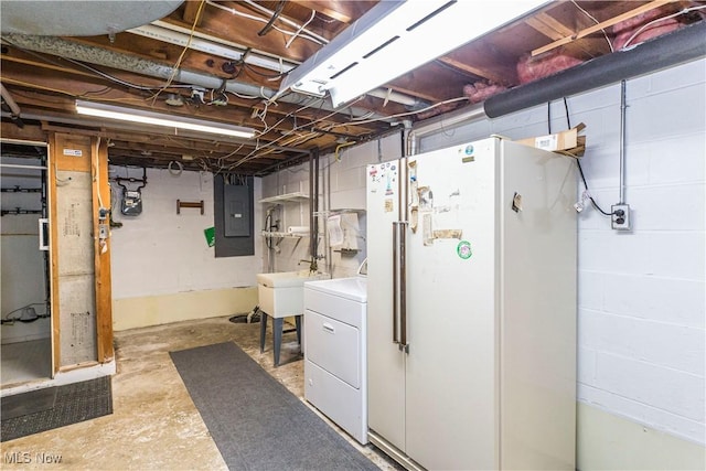 basement with electric panel, white refrigerator, sink, and washer / clothes dryer