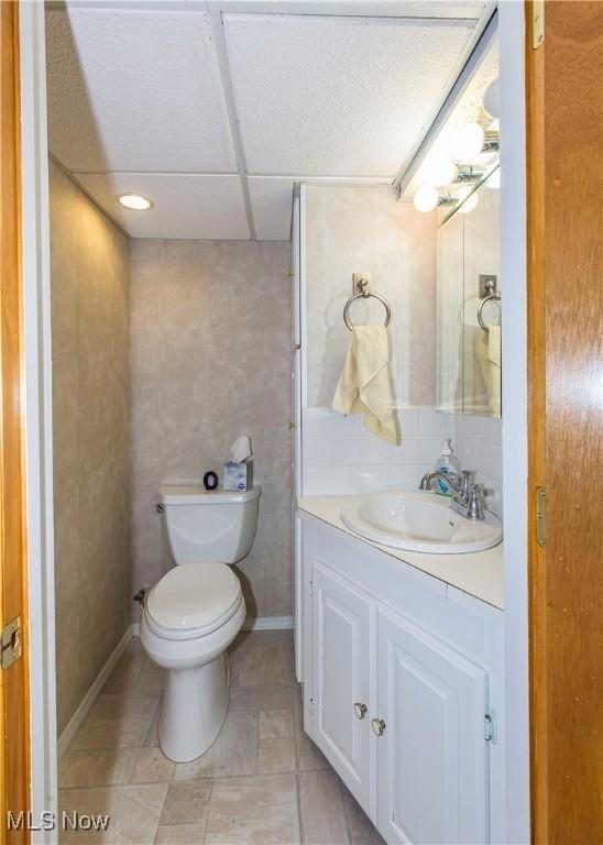 bathroom with tile patterned flooring, vanity, and toilet