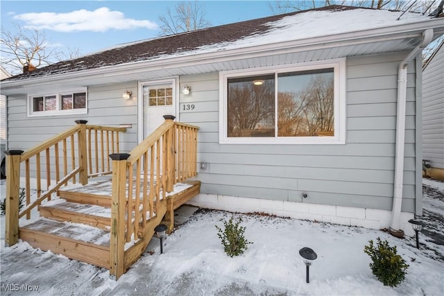 view of snow covered property entrance