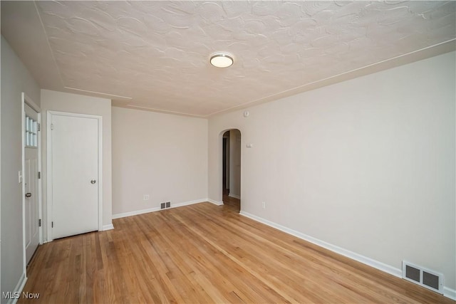 spare room with light hardwood / wood-style flooring