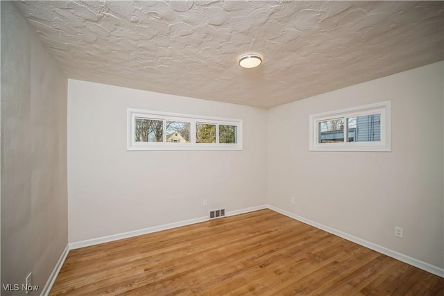 interior space with wood-type flooring and a textured ceiling