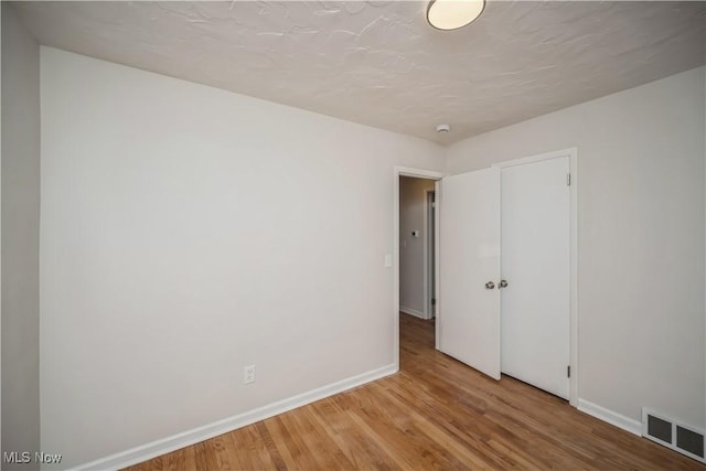 spare room with light hardwood / wood-style flooring