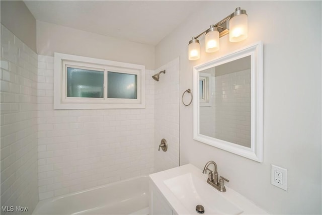 bathroom with sink and tiled shower / bath