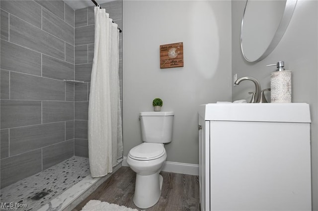 bathroom with a shower with curtain, hardwood / wood-style flooring, and toilet