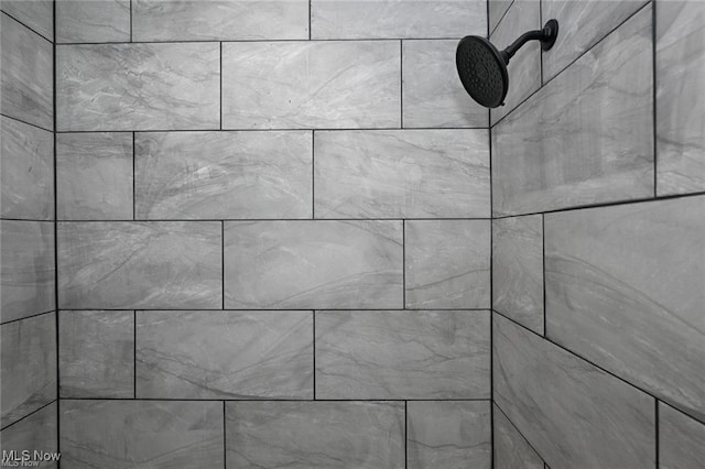 interior details with a tile shower