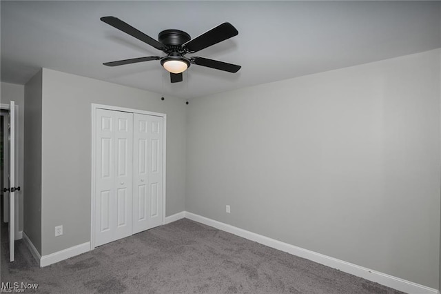 unfurnished bedroom with carpet flooring, ceiling fan, and a closet