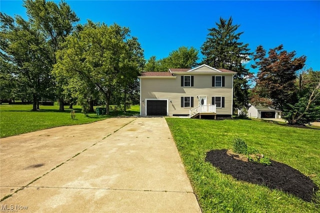 view of front of property featuring a front yard and a garage