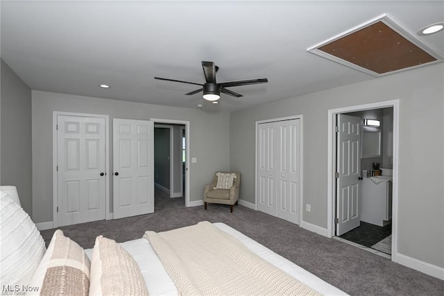 bedroom with ceiling fan, dark carpet, and multiple closets