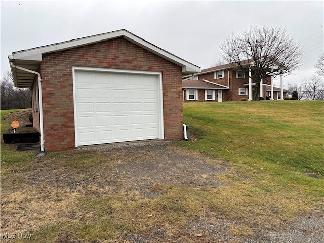 garage featuring a lawn