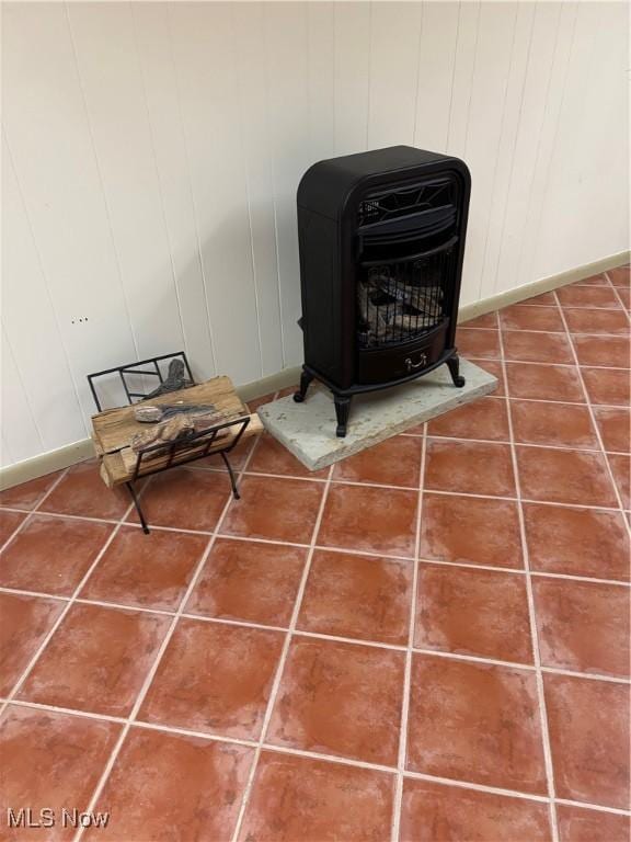 interior details featuring wood walls and a wood stove