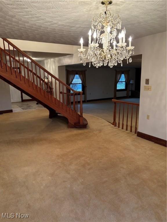 interior space with carpet flooring, a notable chandelier, and a textured ceiling