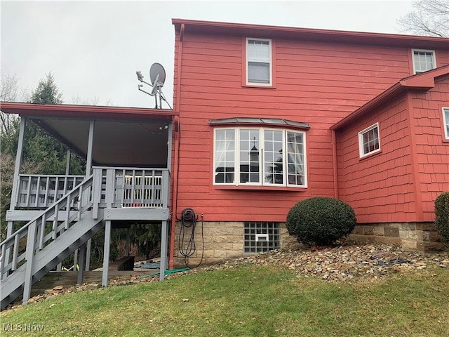 rear view of property with a yard