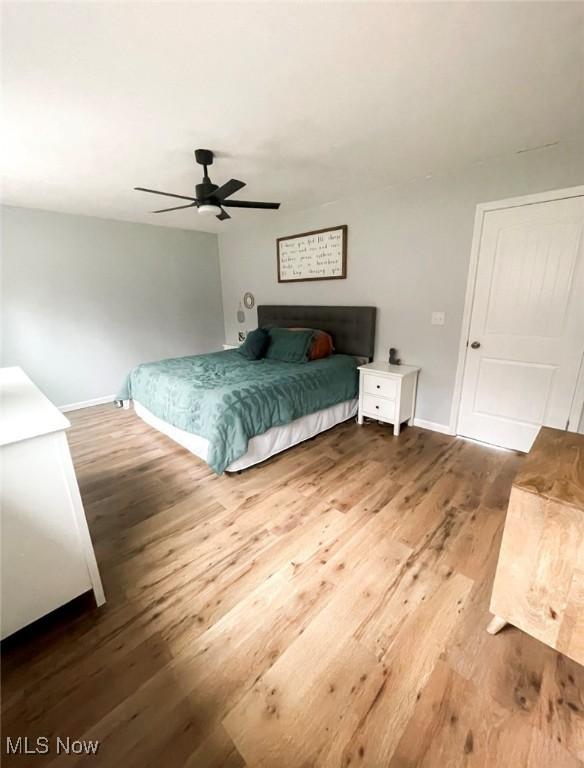 bedroom with ceiling fan and wood-type flooring