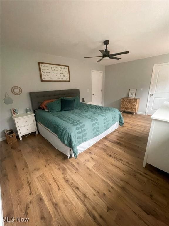 bedroom with ceiling fan and hardwood / wood-style flooring