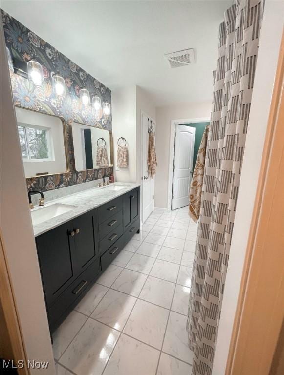 bathroom with tile patterned flooring and vanity