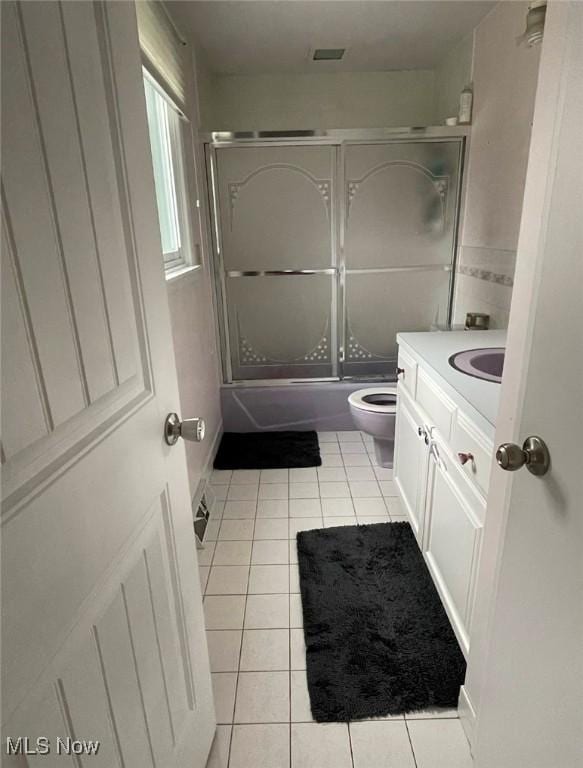 full bathroom featuring tile patterned flooring, vanity, and enclosed tub / shower combo