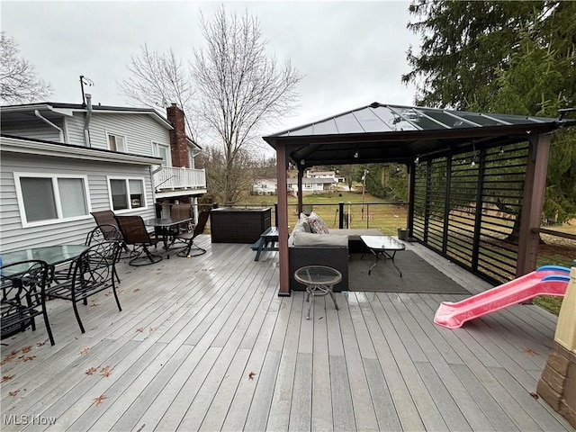 wooden terrace with a gazebo and an outdoor living space