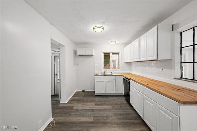 kitchen with wood counters, white cabinets, dark hardwood / wood-style floors, and sink