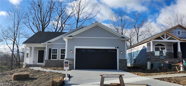 craftsman-style home with a garage and central AC unit