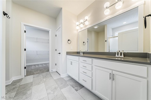 bathroom with vanity and a shower with shower door