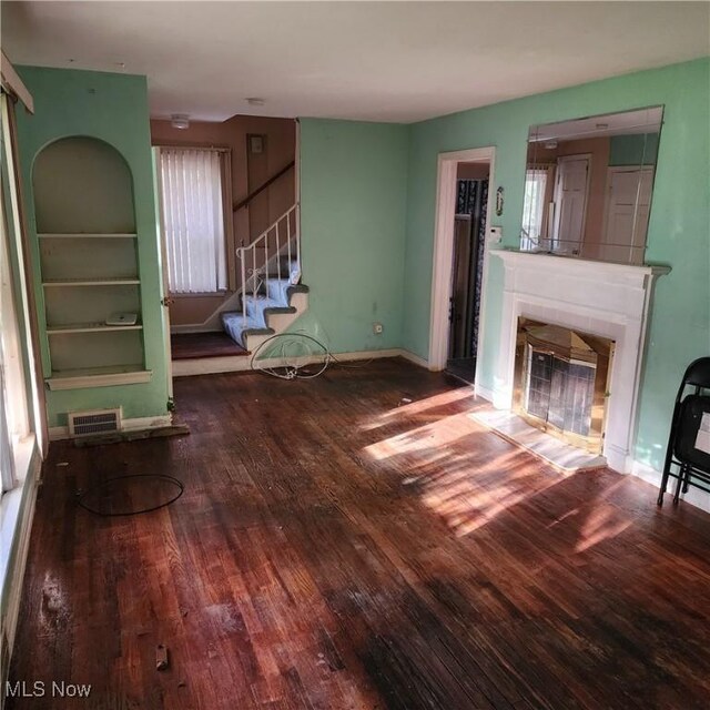 unfurnished living room featuring hardwood / wood-style flooring