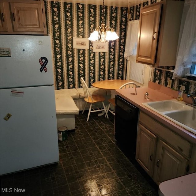 kitchen with pendant lighting, dishwasher, an inviting chandelier, white refrigerator, and sink