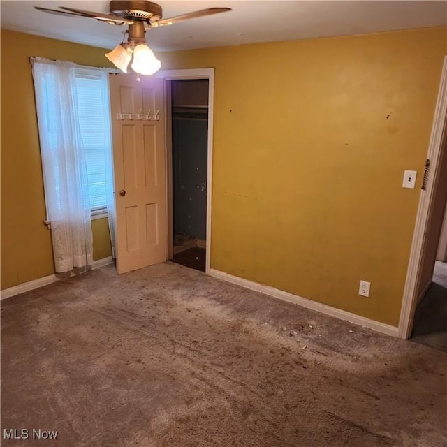 unfurnished bedroom with ceiling fan, a closet, and carpet floors