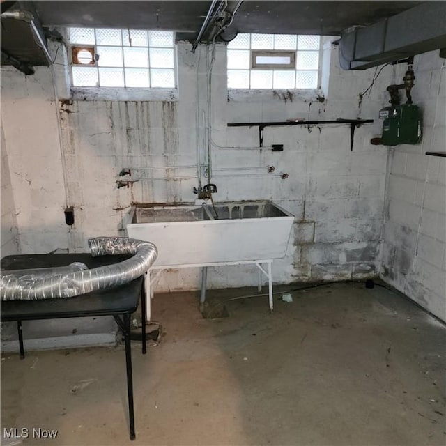 basement with sink and a healthy amount of sunlight