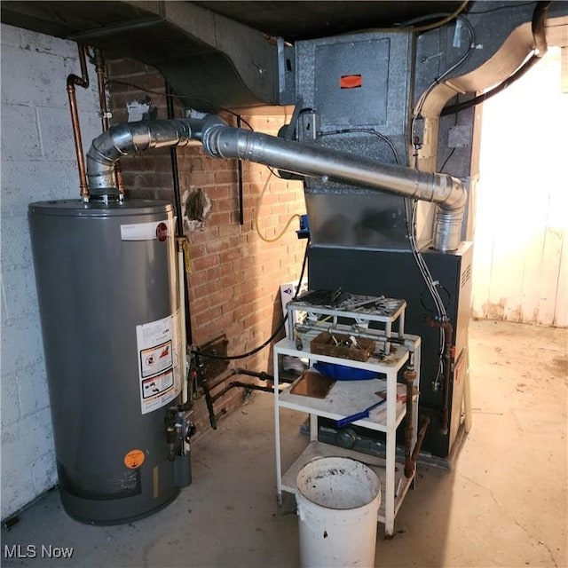 utility room featuring water heater