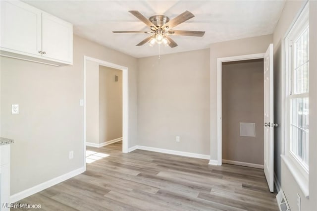 empty room featuring ceiling fan and light hardwood / wood-style floors