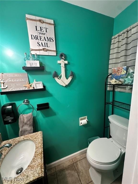 bathroom featuring tile patterned flooring, toilet, and sink