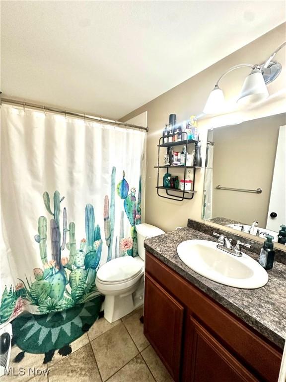 bathroom with tile patterned floors, vanity, and toilet