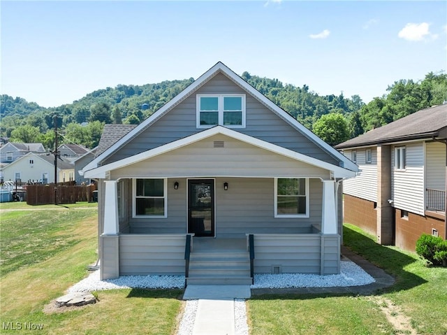 bungalow-style home with a front yard