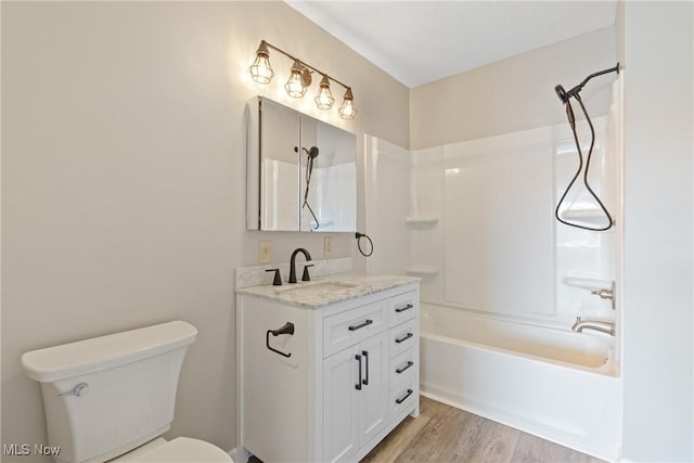 full bathroom with hardwood / wood-style flooring, vanity, toilet, and shower / tub combination