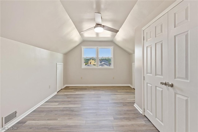 additional living space with ceiling fan, light hardwood / wood-style floors, and lofted ceiling